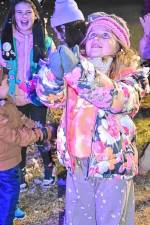 <b>Children catch flakes from the snow-making machines at the annual Christmas Tree Lighting Ceremony on Monday, Dec. 2 in front of the West Milford municipal building. (Photo by Rich Adamonis)</b>