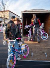 Members of the Warlocks Motorcycle Club, based in Hardyston, unload some of the toys, worth $10,000, that they donated to Toys for Tots. This is the third year that the group has raised funds for the project.