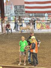 <b>Lisa Chammings presents an award to Tanner Goytile on Thursday, Aug. 8 at the New Jersey State Fair-Sussex County Farm &amp; Horse Show. Behind them is Dave Foord, senior program coordinator of the Sussex County 4-H program. (Photo by Aidan Mastandrea)</b>