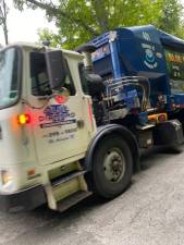 A truck from Blue Diamond Disposal, which took over Ayers’ customers, steams down South Shore Drive in Newton. (Photo by Laurie Gordon)