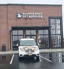 The Maxwell &amp; Molly’s van sits in front of the new store. The van has seen a lot of action during the pandemic delivering pet supplies (Photo by Laurie Gordon)