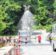 Children cool off in spray from the Fire Department’s ladder truck at Stanhope Family Fun Day on Sunday, July 14 at Lake Musconetcong Park. (Photos by Fred Ashplant)