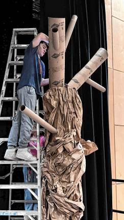 <b>A student works on a set piece for ‘Big Fish: School Edition.’</b>