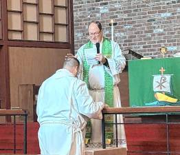 Bishop Stephen Gewecke, president of the New Jersey District of the Lutheran Church-Missouri Synod, installs Peter Naumowicz as the new congregational lay deacon at Redeemer Lutheran Church in Andover Township. (Photo provided)