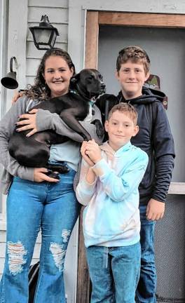 From left, Harmony, Abel and Blake Buckovitch with their dog Dotty.