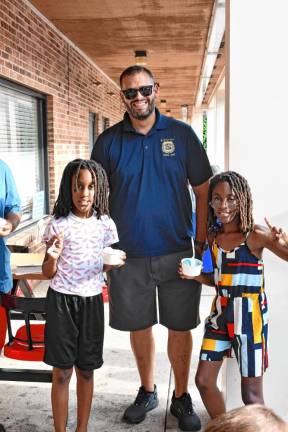 CC3 Hudson and Nairobi Ndombi of Byram pose with Byram Police Officer Christopher Spaldo.