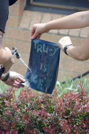 Artist Carole Loeffler washes cyanotype with Trinity Hartung (Photo by Laura J. Marchese)