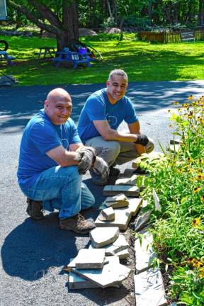 <b>Rich Clemente of Boonton and Melvin Pena of New Windsor, N.Y., fix the curb.</b>