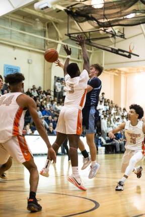 Sparta's Jonathan Cristillo tries for a basket as Hackettstown's Andrew Moussignac blocks him. Cristillo was the Most Valuable Player in the finals.