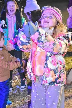 Children catch flakes from the snow-making machines at the annual Christmas Tree Lighting Ceremony on Monday, Dec. 2 in front of the West Milford municipal building. (Photo by Rich Adamonis)