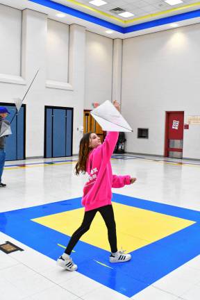 Charlie Reid flies a kite in the Byram Lakes School cafeteria.