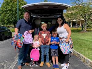 <b>The Saporito Family donated backpacks to Project Self-Sufficiency in 2023.</b>