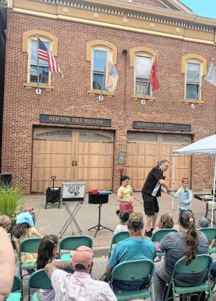 A magician named Tommy Knucklehead performs in front of the Newton Firehouse. (Photo by Aidan Mastandrea)