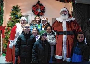 Santa and Mrs. Claus pose with children at the Tree Lighting on Friday, Dec. 6 in Newton. (Photo by Nancy Madacsi)