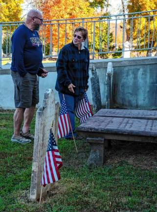 RW3 Peter Litchfield, commander of Veterans of Foreign Wars Post #7248 in Sparta, and Wendy Wyman, a trustee of the Sussex County Historical Society, with flags and grave markers.