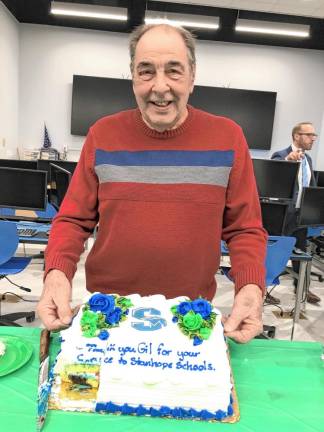 Gil Moscatello, vice president of the Board of Education, with a cake in his honor.