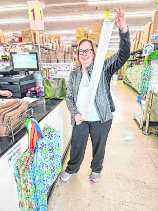 SH1 Cynthia Allen, president of the Rotary Club of Branchville, holds the register tape from the group’s shopping trip to Ocean State Job Lots in Sparta. They spent slightly less than $2,000 on items for the Sussex County Food Pantry. (Photo provided)