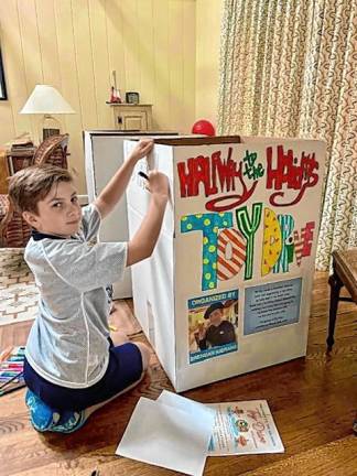 Brendan Kierans, 11, of Sparta decorates a box to collect donated toys. (Photo provided)