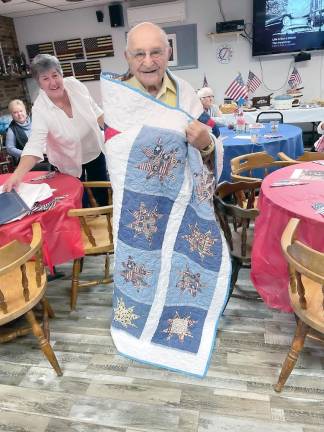 Ceremony organizer Judith Williams with veteran Eddie Mindlin, who appreciates his comforting Quilt of Valor. (Photo courtesy of Carol Johnson)