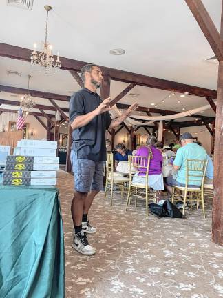 Benjamin Davey speaks to participants in the golf outing.