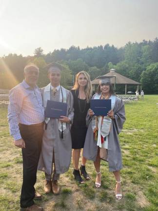 Hosam Masih and Joy Makich pose with their children, Max and Sam Masih, right, after they graduated from Sussex County Community College.