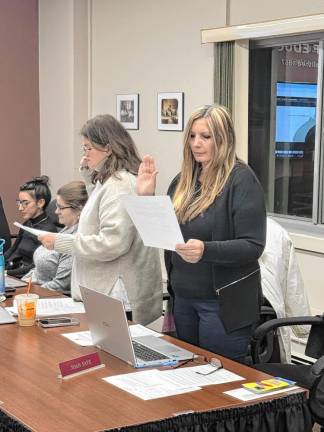 Meghan Gill, left, and Joan Faye take their oaths of office.