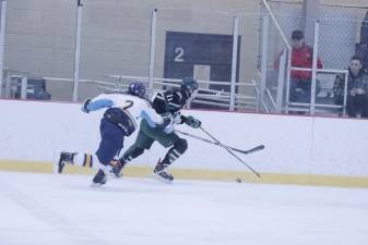 Sparta-Jefferson United's Chris D'Alauro and Livingston's Matt Mclaughlin pursue the puck during the first period.