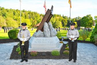 Bob Caggiano of Hardyston and Anne Erickson of Fredon from Bugles Across America stand by the 9/11 Memorial at Sussex County Community College at the ceremony Wednesday, Sept. 11. (Photos by Maria Kovic)