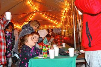 <b>Residents get drinks during the Festival of Lights celebration Saturday, Nov. 16 at the Newton Medical Center. (Photo by Maria Kovic)</b>