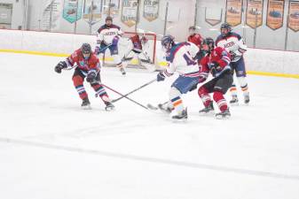 Players for the Newton/Lenape Valley co-op squad and Mountain Lakes battle for control of the puck Dec. 14. Newton/Lenape Valley won, 3-2. (Photos by George Leroy Hunter)