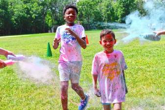 Boys are sprayed with color during the Color Run on Sunday, June 2 at Byram School. (Photo by Maria Kovic)
