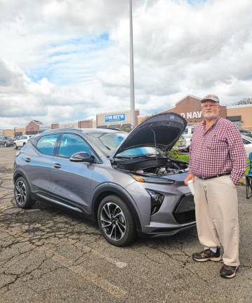 EV2 Ken Hunold of Hackettstown shows off his electric car at the event.
