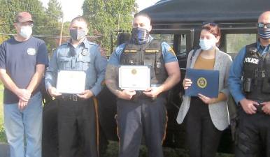 Lauren Gonnelli of U.S. Rep. Josh Gottheimer’s office presents certificates to local police and fire departments and the church for their participation in the 2020 toy drive (Photo by Janet Redyke)