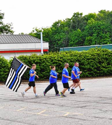 Law enforcement members carry the Special Olympics torch in Franklin. This year, about 3,000 people were expected to take part in the run, a day-long event split into 26 legs. The run travels through more than 300 towns, covering 750 miles. The Summer Games will be June 9-11 at the College of New Jersey. (Photo by Maria Kovic)