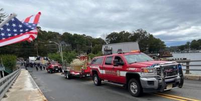 <b>A Hopatcong Fire Department vehicle pulls a trailer carrying trophies during the annual Inspection Day Parade last year. (File photo by Daniele Sciuto)</b>