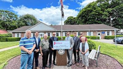 Rep. Tom Kean Jr., R-7, fourth from right, presents a ceremonial check for $3.3 million to Stanhope officials June 10. The federal funds will pay for installation of a water tower for the borough.