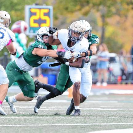 <b>Tylik Hill of Pope John tries to break free on a run in the second quarter. (Photo by Glenn Clark)</b>