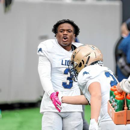 Tylik Hill of Pope John yells in celebration on the Lions’ sideline after his second-half touchdown.