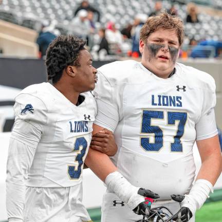 Tylik Hill consoles Pope John teammate Evan Kennedy after their 33-21 loss to DePaul.