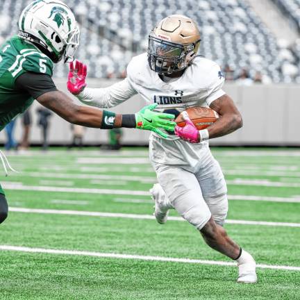 Pope John’s Tylik Hill puts out a stiff arm on a run around the left end against DePaul.