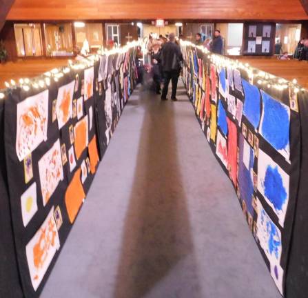 Artwork inspired by the storybook Mix It Up lines the aisle of the Lutheran Church of Our Savior during the Our Savior Nursery School art gala on Thursday, Feb 27, 2020. This work was created by the school's 3s Class for the event.