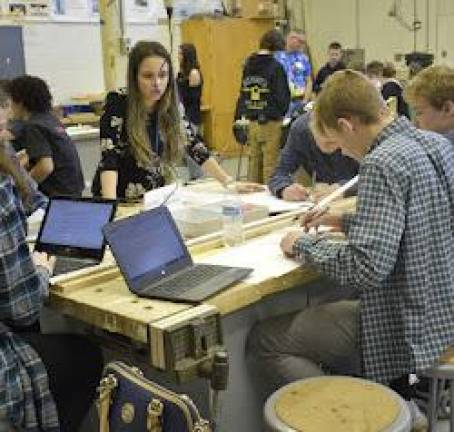 Teams of students use their problem-solving skills to handle the crash-dummy test. (Photos courtesy of Brian Drelick)