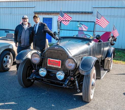 <b>John Busco, left, of the Wanderers Car Club with parade grand marshal Emerson Crooks, retired from the U.S. Marine Corps.</b>