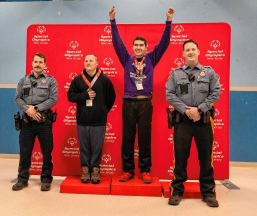 <b>Hardyston Police Officers Jared Kodis, left, and Justin Edelbach, right, with speed skaters Joseph Pilchuk and Robert Lieu. (Photo by Nancy Madacsi)</b>