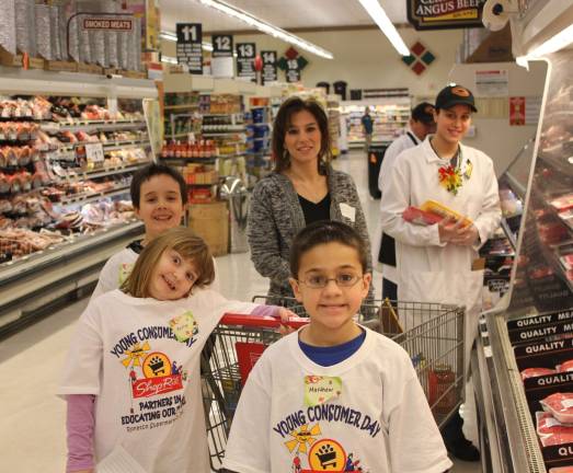 Photo Provided In front is Matthew Makaus. Behind him are Kaitlyn Dixon and Michael Totaro. The students are assisted by parent volunteer Cheryl Rhine while ShopRite associate Amanda Castro looks on.