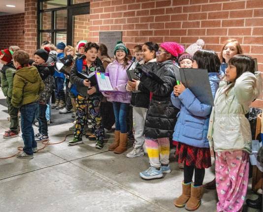 The Merriam Avenue Elementary School choir performs at the Tree Lighting on Friday, Dec. 6 in Newton. (Photos by Nancy Madacsi)