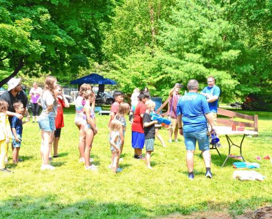 Children line up to try the water gun.