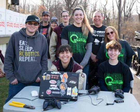 Newton High School robotics team members Salvatore Serillo, Ariel Franzone, Rich Murray, Dawn Murray and Josh Murray with assistant coach Lisa Holder, coach Ciara Roman, and mentors Steve Fosozone and Edward Holder.