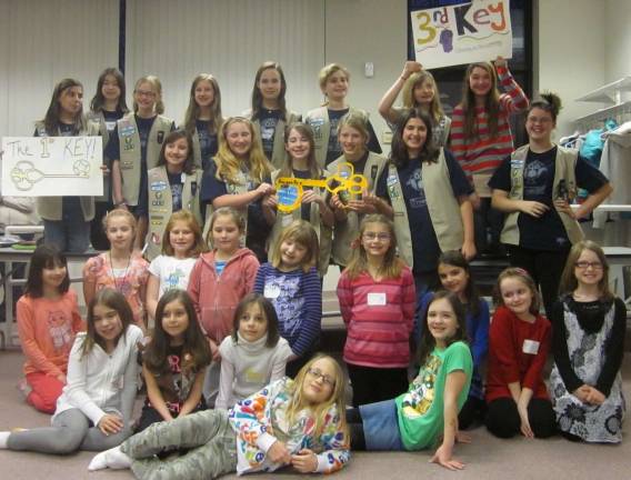 Photo Provided Cadette Troop 911 (back) and Brownie Troop 823 (front).