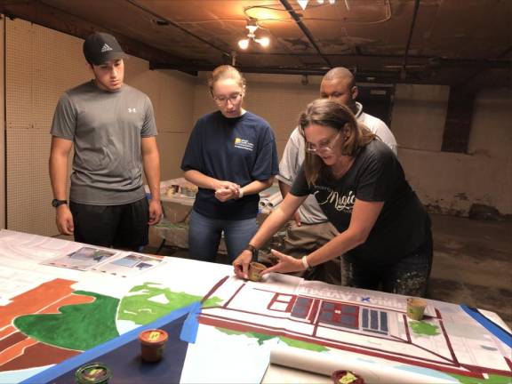 From left, Aldo Monge, Hannah Gallagher and Caiden Schabacker listen to instructions from artist Caren Olmsted.